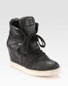 Fronted by laces and a Velcro® strap, this sporty leather sneaker has an unexpected, hidden wedge and rubber sole. Hidden wedge, 3 (75mm)Leather upperLeather liningRubber solePadded insoleImported