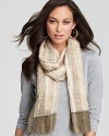 A guazy finish lends bohemian inspiration to a striped Eileen Fisher scarf.