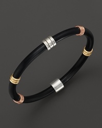 Rings of yellow gold, rose gold and sterling silver embellish a modern rubber bangle.Handcrafted in the USA by master jewelers, this simple but elegant bracelet will be a welcome addition to any jewelry collection. Rings of yellow gold, rose gold and sterling silver embellish a modern rubber bangle.Handcrafted in the USA by master jewelers, this simple but elegant bracelet will be a welcome addition to any jewelry collection.