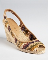 Coated raffia makes a colorful appearance on Andre Assous' Payton wedges, boasting a vibrant zigzag pattern on a slingback silhouette. Coated raffia makes a colorful appearance on Andre Assous' Payton wedges, boasting a vibrant zigzag pattern on a slingback silhouette.