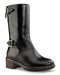 The moto boot goes chic and shiny with pared-down buckles and a discreet row of studs. A cozy lining keeps toes warm. From UGG® Collection. The moto boot goes chic and shiny with pared-down buckles and a discreet row of studs. A cozy lining keeps toes warm. From UGG® Collection.
