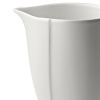 Borrowing from nature, this porcelain creamer has a highly glossed surface and unusual contours, creating an interesting silhouette - a DVF signature - on the table.