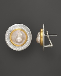 Modern button earrings in sterling silver and 24K yellow gold with Mabe pearl center. Modern button earrings in sterling silver and 24K yellow gold with Mabe pearl center.