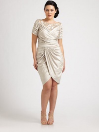 Mesmerizing is the only word that can describe this satin dress. It features a gorgeous, embellished neckline and allover gathered details that will be oh-so-flattering on your curvy figure.Embellished-mesh necklineShort sleevesRuched bodiceTulip skirtConcealed back zipperAbout 26 from natural waist92% polyester/8% spandexDry cleanImported Mesmerizing is the only word that can describe this satin dress. It features a gorgeous, embellished neckline and allover gathered details that will be oh-so-flattering on your curvy figure.Embellished-mesh necklineShort sleevesRuched bodiceTulip skirtConcealed back zipperAbout 26 from natural waist92% polyester/8% spandexDry cleanImported