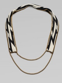 A dramatic look formed of black and white beads in a striking tribal design on a flat strap, framed and finished with bold golden chains.GlassGoldtoneCotton backingLength, about 20¾Imported