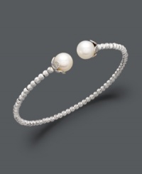 Add class to any look with polished pearls and a touch of shimmer. This sterling silver bangle bracelet features a unique beaded design that highlights two cultured freshwater pearls (8-1/2-9 mm) at the ends. Approximate diameter: 2-1/2 inches.
