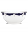 A show-stopping serving bowl from Marchesa by Lenox, this Empire Indigo dinnerware wows everyone around the formal table with a bedazzling platinum pattern in fine bone china.