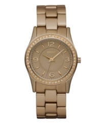 Hints of caramel shine on this mini watch by DKNY. Rose-gold tone aluminum bracelet and round rose-gold aluminum-plated stainless steel case. Bezel embellished with crystal accents. Rose-gold tone dial features applied rose-gold tone numerals at twelve, three, six and nine o'clock, stick indices, minute track, three hands and logo. Quartz movement. Water resistant to 50 meters. Two-year limited warranty. Hints of caramel shine on this mini watch by DKNY. Rose-gold tone aluminum bracelet and round rose-gold aluminum-plated stainless steel case. Bezel embellished with crystal accents. Rose-gold tone dial features applied rose-gold tone numerals at twelve, three, six and nine o'clock, stick indices, minute track, three hands and logo. Quartz movement. Water resistant to 50 meters. Two-year limited warranty.