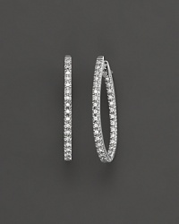 Prong set, inside out oval diamond hoop earrings set in white 14 Kt. gold. With hinged post. Prong set, inside out oval diamond hoop earrings set in white 14 Kt. gold. With hinged post.