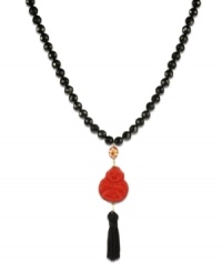 Eastern expressionism. This stunning necklace features shiny onyx beads (240 ct. t.w.), a carved cinnabar buddha pendant, and a black nylon tassel. Set in 18k gold over sterling silver. Approximate length: 30 inches. Approximate drop: 4 inches. Eastern expressionism. This stunning necklace features shiny onyx beads (240 ct. t.w.), a carved cinnabar buddha pendant, and a black nylon tassel. Set in 18k gold over sterling silver. Approximate length: 30 inches. Approximate drop: 4 inches.