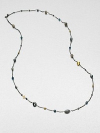 From the Bijoux Collection. Richly colored semi-precious stones in various colors and shapes mix with 18k gold beads on a delicate blackened sterling silver link chain. Hematite, labordarite, grey moonstone and blue topaz18k goldBlackened sterling silverLength, about 40Toggle closureImported 