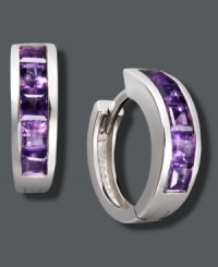 Purple hues give traditional hoops a poignant touch. Set in sterling silver, hoops feature baguette-cut, channel-set amethyst (1-1/2 ct. t.w.). Approximate diameter: 1/2 inch.