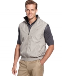 Look great on or off the golf course with this water resistant wind vest by Greg Norman for Tasso Elba. Look great on or off the golf course with this water resistant wind vest by Greg Norman for Tasso Elba.