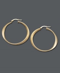 Add a little luxury to your look. Luminous gold hoops are an essential piece in every stylish woman's wardrobe. Earrings feature a unique oval design crafted in 14k gold. Approximate diameter: 1-1/2 inches.