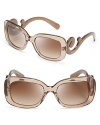 Go for Baroque in Prada's over-the-top sunglasses with statement-making arms.