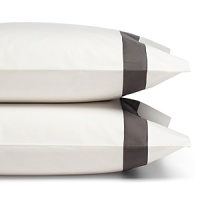 A classic charcoal gray sateen border trims these pillowcases by SFERRA, woven from super soft Egyptian cotton.