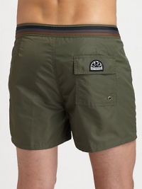 Comfortable swim trunks, in quick-drying nylon, are highlighted by a striped detail along the waistband and back flap pocket with grip-tape closure.Snap button-frontRear flap pocketInseam, about 3NylonMachine washImported