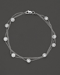 Perfectly elegant, a 3-chain white gold necklace with gleaming diamond stations.