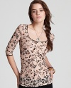 A pretty printed lace top by Free People with unexpected criss-cross black lace strings in back.