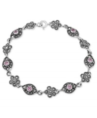 Beauty is in bloom. Genevieve & Grace's link bracelet, crafted from sterling silver, features a flower motif with marcasite and amethyst (1/10 ct. t.w.) enhancing the appeal. Approximate length: 7-1/2 inches. Beauty is in bloom. Genevieve & Grace's link bracelet, crafted from sterling silver, features a flower motif with marcasite and amethyst (1/10 ct. t.w.) enhancing the appeal. Approximate length: 7-1/2 inches.