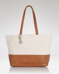 A round the clock wardrobe requires hard working accessories like this tote from DKNY. Crafted from durable nylon with a shoulder-right shape, it's practically perfect (or perfectly practical.) A round the clock wardrobe requires hard working accessories like this tote from DKNY. Crafted from durable nylon with a shoulder-right shape, it's practically perfect (or perfectly practical.)