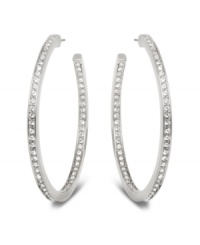 Stellar style fit for a celebrity. This elegant pair of silver tone mixed metal hoop earrings sparkles in clear Swarovski crystal pavé and reflects the light in a thousand facets. These unique earrings add a touch of sophistication to your look. Approximate diameter: 1-7/8 inches.