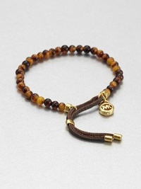 Glossy tortoise-print beads accented with supple leather detail. AcetateGoldtoneLeatherDiameter, about 2.25Slip-on styleImported Glossy tortoise-print beads accented with supple leather detail. AcetateGoldtoneLeatherDiameter, about 2.25Slip-on styleImported