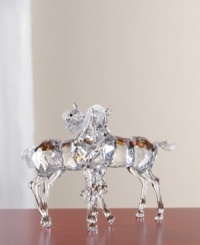 Two nuzzling foals crafted of sparkling crystal. The multi-faceted body and neck are a stunning contrast to the matte crystal mane and tale. Smokey topaz eyes infuse a warm touch of color. Each foal measures 3-3/4 H x 4-2/3 L x 2-1/2 W. Two nuzzling foals crafted of sparkling crystal. The multi-faceted body and neck are a stunning contrast to the matte crystal mane and tale. Smokey topaz eyes infuse a warm touch of color. Each foal measures 3-3/4 H x 4-2/3 L x 2-1/2 W.