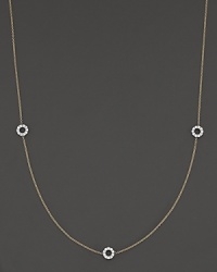 A delicate yellow gold chain with three double-sided white gold diamond circle stations. A delicate yellow gold chain with three double-sided white gold diamond circle stations.