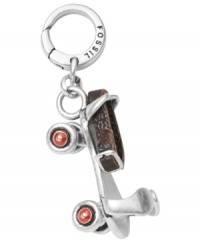 Transport yourself back to the 1950s with this vintage-inspired roller skate charm. Fossil's antique-themed style features red enamel wheels that actually spin and a real leather ankle strap. Set in silver tone mixed metal. Approximate drop: 1-1/4 inches. Transport yourself back to the 1950s with this vintage-inspired roller skate charm. Fossil's antique-themed style features red enamel wheels that actually spin and a real leather ankle strap. Set in silver tone mixed metal. Approximate drop: 1-1/4 inches.