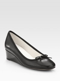 An elevated self-covered wedge silhouette of patent leather, topped with a pretty grosgrain bow. Self-covered wedge, 1½ (40mm)Leather and grosgrain upperLeather liningRubber solePadded insoleMade in France An elevated self-covered wedge silhouette of patent leather, topped with a pretty grosgrain bow. Self-covered wedge, 1½ (40mm)Leather and grosgrain upperLeather liningRubber solePadded insoleMade in France