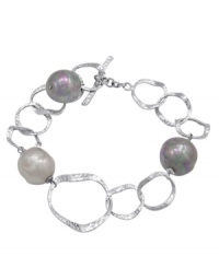 Hammered metal circles of sterling silver shine alongside multicolor iridescent, organic, man-made baroque pearls in this bracelet by Majorica. Approximate length: 7-1/4 inches. Hammered metal circles of sterling silver shine alongside multicolor iridescent, organic, man-made baroque pearls in this bracelet by Majorica. Approximate length: 7-1/4 inches.