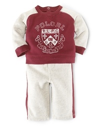 This coordinating athletic set includes a classic crewneck fleece pullover and matching sweatpant with contrast stripes for an authentic sporty look. This coordinating athletic set includes a classic crewneck fleece pullover and matching sweatpant with contrast stripes for an authentic sporty look.