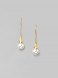 Delicate freshwater pearls dangle from hand-hammered 24k gold settings. 8mm white, round freshwater pearls 24k yellow gold Length, about 1¼ 22k gold ear wire Imported