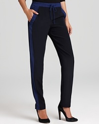 These Vince pants are right on track for trend-right style. Made of silk with color block tuxedo stripes, these comfy-luxe bottoms hit all the fashion high notes. These Vince pants are right on track for trend-right style. Made of silk with color block tuxedo stripes, these comfy-luxe bottoms hit all the fashion high notes.
