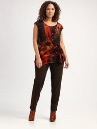 Featuring a bold, abstract look, a silk top with a flattering side tie and gathered details.Round neckCap sleevesAllover printSide tie at draped waistAbout 27 from shoulder to hemSilkDry cleanImported