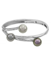 Ocean-inspired style. Embellish your wrist with this coral-like bangle by Majorica. Set in sterling silver, three soft-hued organic man-made pearls (12 mm) are accentuated by cubic zirconia details. Approximate diameter: 2-1/2 inches. Ocean-inspired style. Embellish your wrist with this coral-like bangle by Majorica. Set in sterling silver, three soft-hued organic man-made pearls (12 mm) are accentuated by cubic zirconia details. Approximate diameter: 2-1/2 inches.