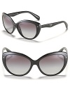 Prada's cat eye sunglasses with thick frames and metal triangle stud accents, the must-have accessory of the season.