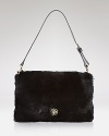 This Tory Burch clutch does evening with an edge. Crafted of rabbit fur with leather trims, it's a look-maker after-hours.