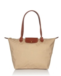 Longchamp's signature nylon tote in a large size lends sophisticated chic to every look, from city jaunts to weekend getaways. Folds up for ease during travel. Longchamp's signature nylon tote in a large size lends sophisticated chic to every look, from city jaunts to weekend getaways. Folds up for ease during travel.