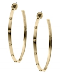 Bring some edge to a timeless look. Michael Kors added stud detail to a classic metal hoop earring. Crafted in gold tone mixed metal. Approximate diameter: 2 inches. Bring some edge to a timeless look. Michael Kors added stud detail to a classic metal hoop earring. Crafted in gold tone mixed metal. Approximate diameter: 2 inches.