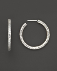 Pure silver hoops with a hammered texture add a quiet elegance to your look. Pure silver hoops with a hammered texture add a quiet elegance to your look.