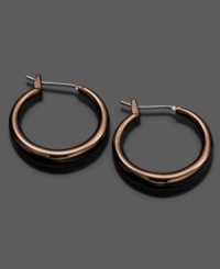 Fossil spices up traditional hoops with a chic ionic brown plating. Earrings crafted in mixed metal. Approximate diameter: 3/4 inches. Fossil spices up traditional hoops with a chic ionic brown plating. Earrings crafted in mixed metal. Approximate diameter: 3/4 inches.