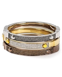 This Michael Kors bangle elevates simple style in gold tone plated metal with delicate crystal stones. Slip it on for a hit of minimalist glamour. This Michael Kors bangle elevates simple style in gold tone plated metal with delicate crystal stones. Slip it on for a hit of minimalist glamour.