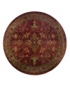 A truly charming interpretation of a traditional carpet, this round rug features a center medallion ringed by palmettes and floral details in sage green, topaz and slate blue against a rich burgundy ground. Striated effects create the weathered look of handmade rugs in a stain-resistant, no-shed manmade fiber.