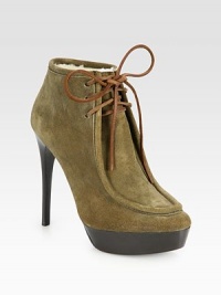 Trend-forward platform ankle boot rendered in buttery suede, with leather laces and warm shearling lining. Stacked heel, 5¼ (130mm)Stacked platform, 1¼ (30mm)Compares to a 4 heel (100mm)Suede upper with leather lacesShearling liningLeather solePadded insoleMade in Italy Trend-forward platform ankle boot rendered in buttery suede, with leather laces and warm shearling lining. Stacked heel, 5¼ (130mm)Stacked platform, 1¼ (30mm)Compares to a 4 heel (100mm)Suede upper with leather lacesShearling liningLeather solePadded insoleMade in Italy