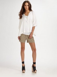 Beautifully draped, this silk-rich, zip-front crewneck has three-quarter sleeves and a split hi-low hem. Zip-down crewneckThree-quarter sleevesAsymmetrical, split hi-low hem95% silk/5% spandexDry cleanImported Beautifully draped, this silk-rich, zip-front crewneck has three-quarter sleeves and a split hi-low hem. Zip-down crewneckThree-quarter sleevesAsymmetrical, split hi-low hem95% silk/5% spandexDry cleanImported