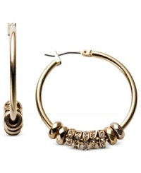 Adding to the glamour, Fossil's hoop earrings, crafted from gold-tone mixed metal, get an extra bit of elegance with shiny rondelles for a stunning effect. Approximate drop: 1-1/4 inches. Adding to the glamour, Fossil's hoop earrings, crafted from gold-tone mixed metal, get an extra bit of elegance with shiny rondelles for a stunning effect. Approximate drop: 1-1/4 inches.