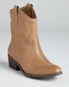 GUESS goes west with the Gennette booties, distinguished by soft taupe leather, a side zip and a stacked heel.
