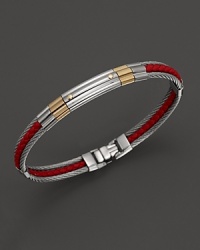 Braided leather pairs with stainless steel and 18K gold on this reinterpretation on Charriol's classic nautical cable bangle. Braided leather pairs with stainless steel and 18K gold on this reinterpretation on Charriol's classic nautical cable bangle.